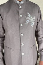 Grey plain kurta set with detailed hand embroidery of a peacock and minimal neck work bundi