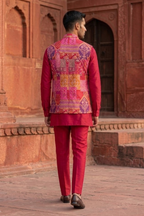Plain red kurta set with mirror work and embroidered jacket
