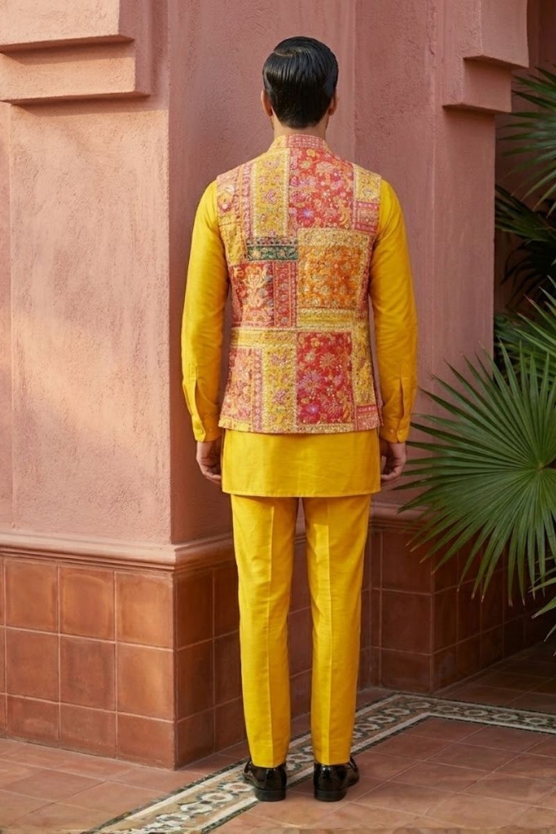 Plain yellow kurta set with mirror work and embroidered jacket