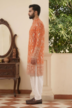 Orange colour kurta top with allover embroidery and pant