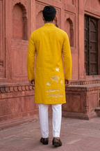 Yellow colour kurta top with sleeves with lotus and hummingbird details and pant