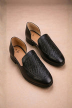 Black leather peshawari sandals with a woven texture on the vamp
