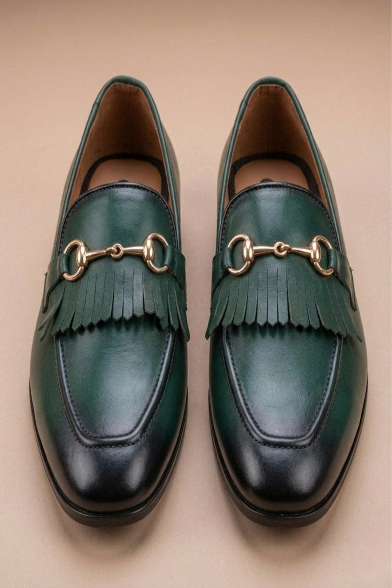 pair of green  horsebit loafers possibly made of leather or synthetic leather,featuring a gold-tone buckle detail and fringe