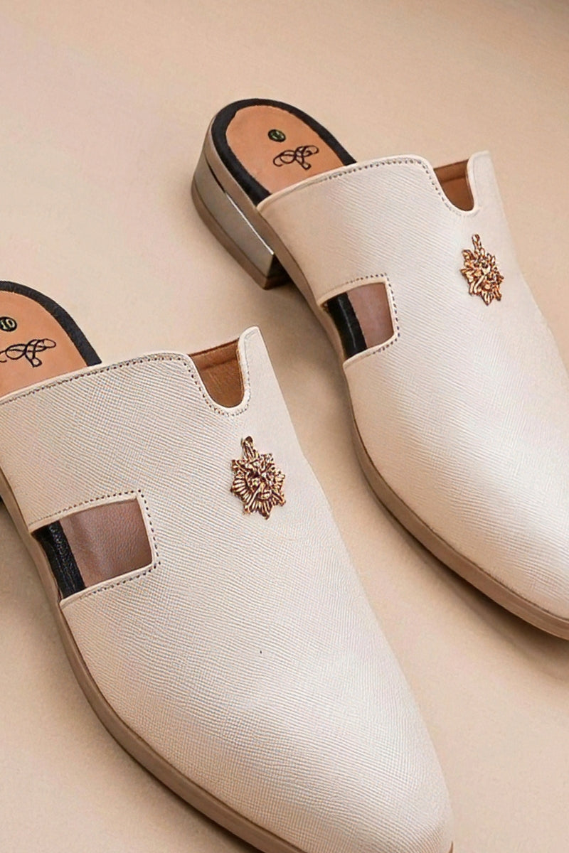 Pair of cream quilted leather backless mules with a gold-tone embellishment