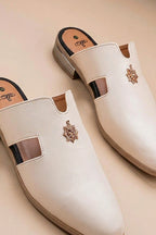 Pair of cream quilted leather backless mules with a gold-tone embellishment