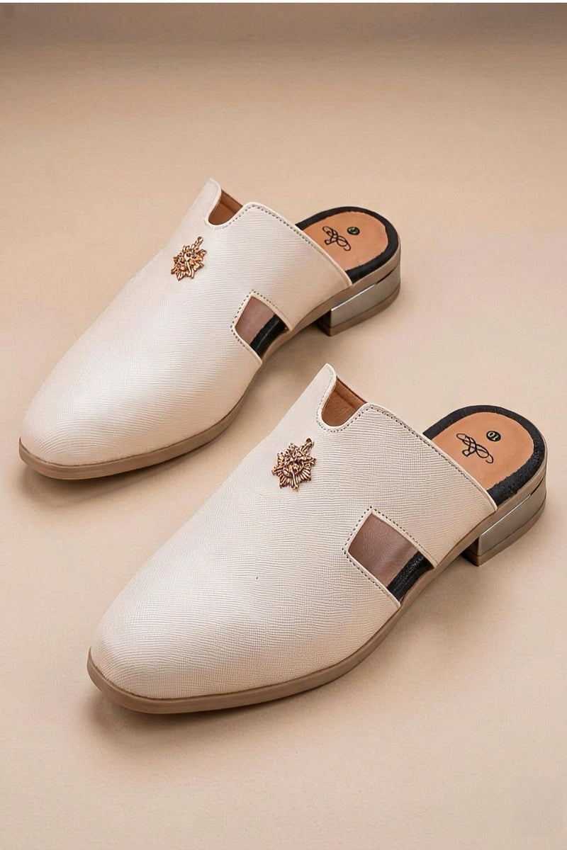 Pair of cream quilted leather backless mules with a gold-tone embellishment