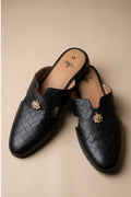 Pair of black  quilted leather backless mules with a gold-tone embellishment