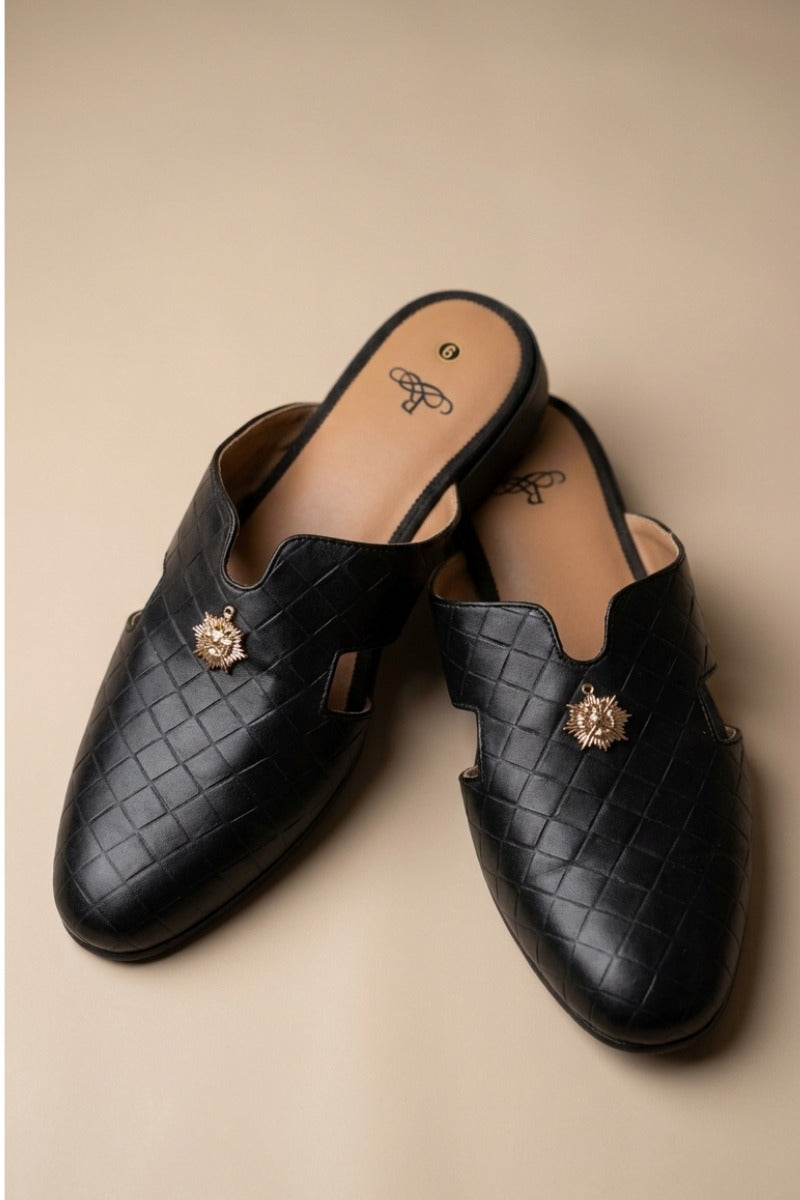 Pair of black  quilted leather backless mules with a gold-tone embellishment