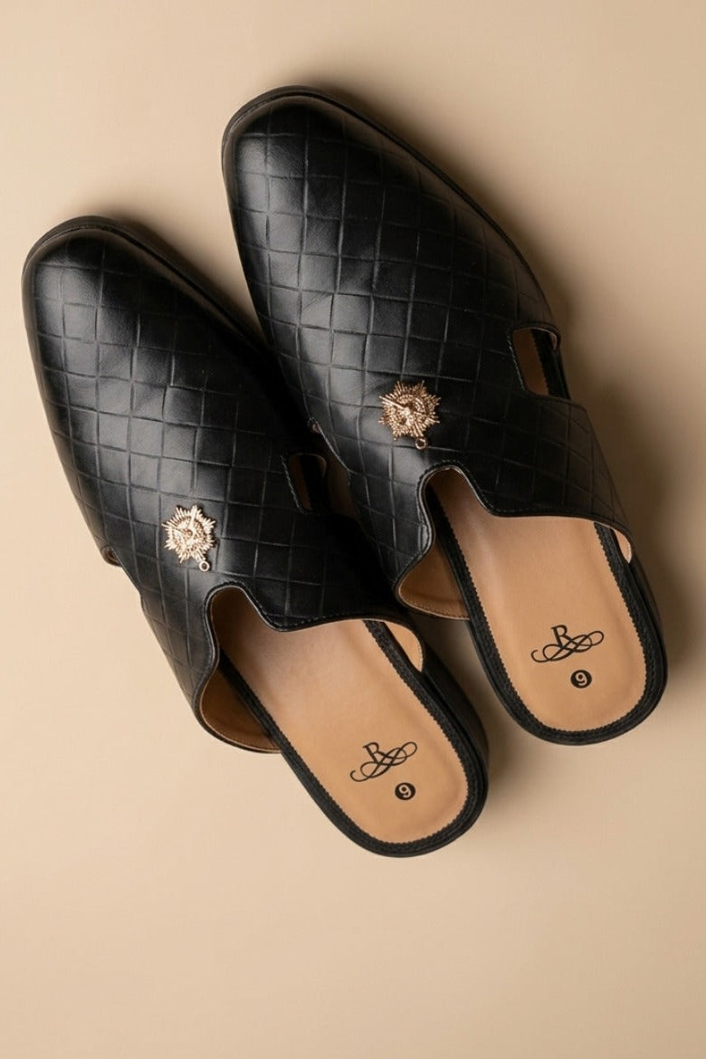Pair of black  quilted leather backless mules with a gold-tone embellishment