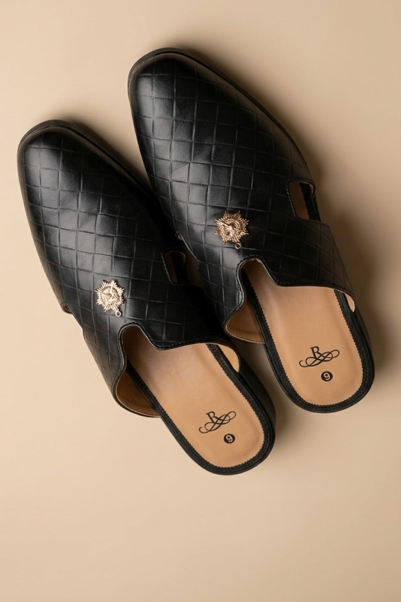 Pair of black  quilted leather backless mules with a gold-tone embellishment