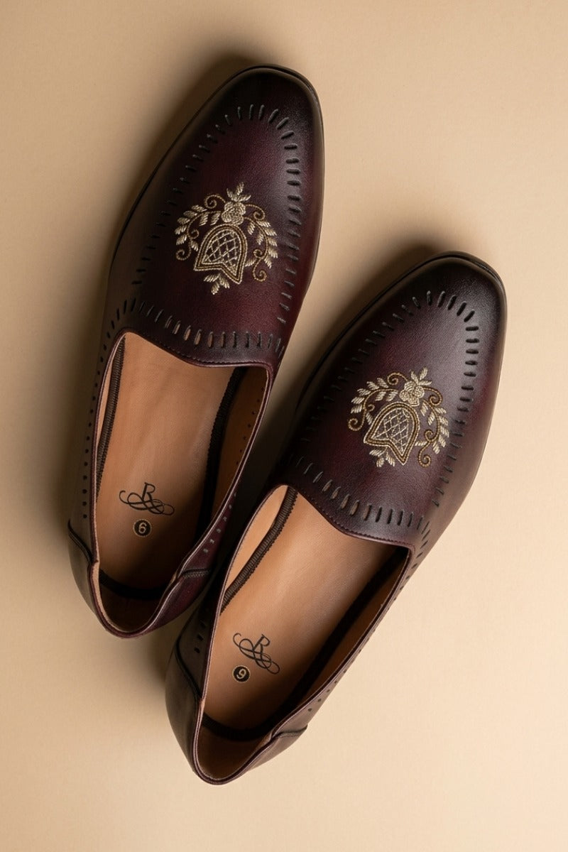 Pair of wine leather sandals with gold embroidery