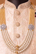 pearl necklace decorated with sparkling stones and made form golden polished metal mala