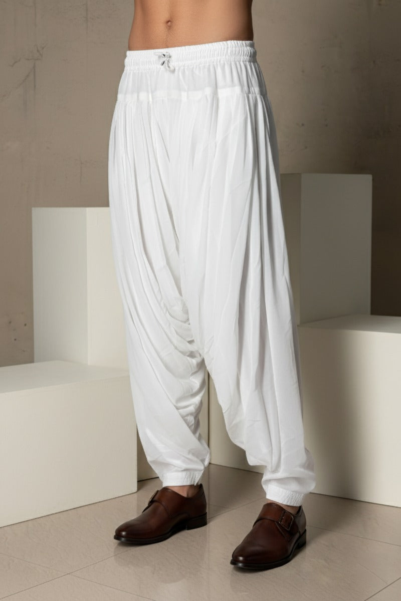 Joorjet white peshawari pant Soft, breathable fabric
Elastic waistband for easy wear
Elegant draped design
Tapered ankle fit
Versatile styling for ethnic and fusion looks