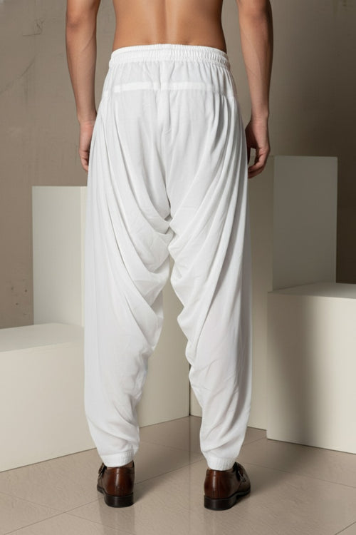 Joorjet white peshawari pant Soft, breathable fabric
Elastic waistband for easy wear
Elegant draped design
Tapered ankle fit
Versatile styling for ethnic and fusion looks