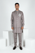 Grey plain kurta set with detailed hand embroidery of a peacock and minimal neck work bundi