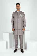 Grey plain kurta set with detailed hand embroidery of a peacock and minimal neck work bundi
