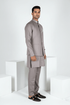 Grey plain kurta set with detailed hand embroidery of a peacock and minimal neck work bundi